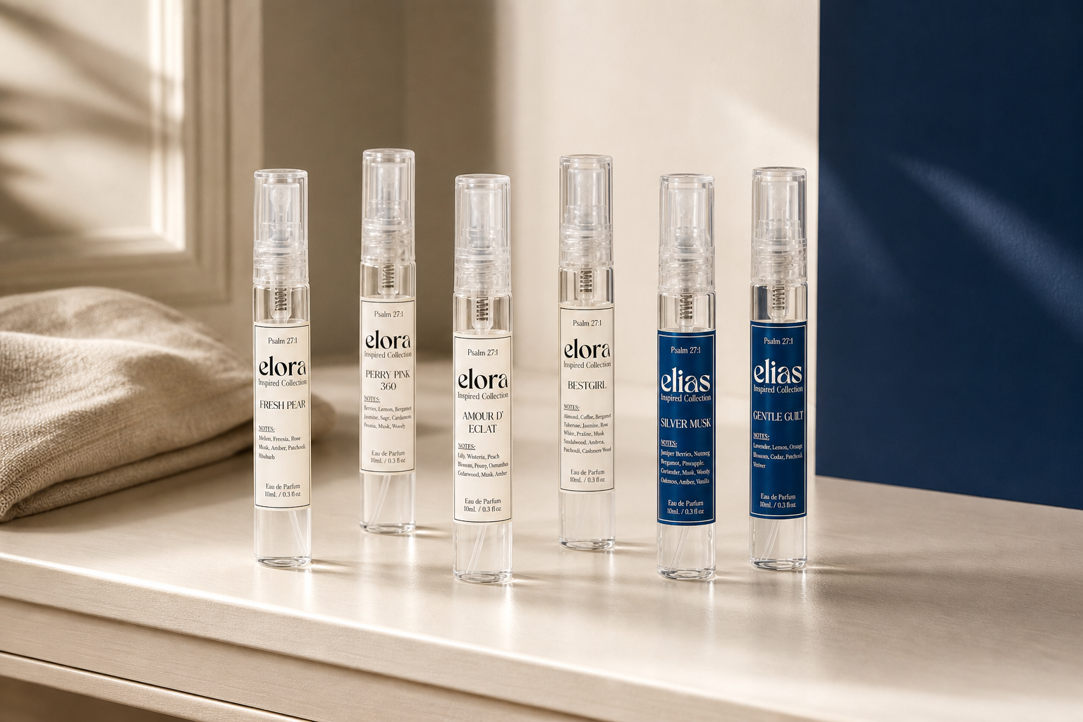 A mixed Elora and Elias 10ml scent wardrobe arranged on a cream vanity shelf.
